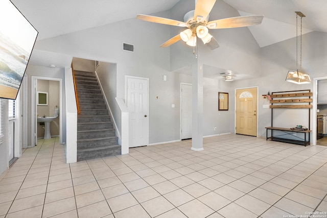 unfurnished living room featuring ceiling fan, light tile patterned floors, and high vaulted ceiling