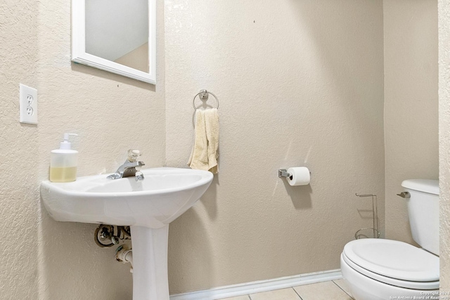 bathroom featuring tile patterned floors and toilet