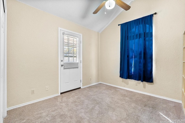 carpeted spare room featuring ceiling fan and vaulted ceiling