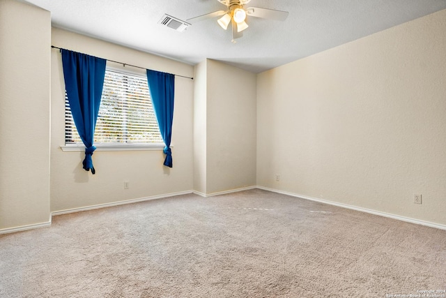 spare room with carpet, ceiling fan, and a textured ceiling