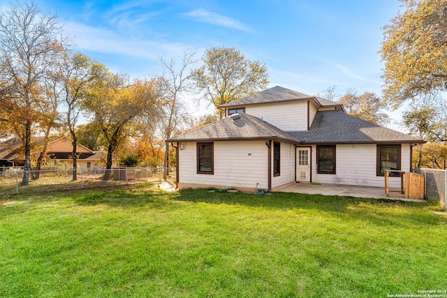 rear view of property with a patio area and a yard