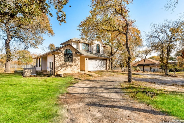 view of front of property with a front yard and a garage