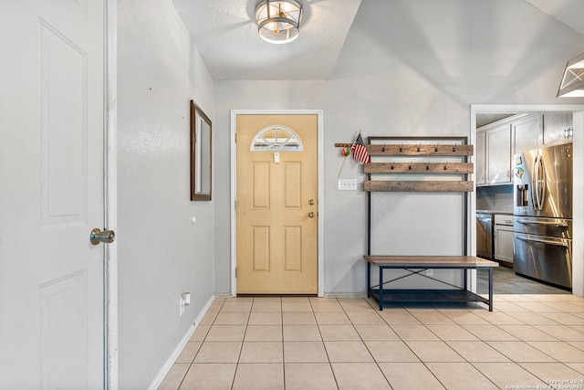 tiled foyer with lofted ceiling