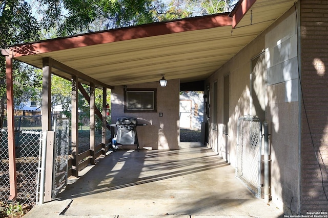 view of patio with a carport and a grill