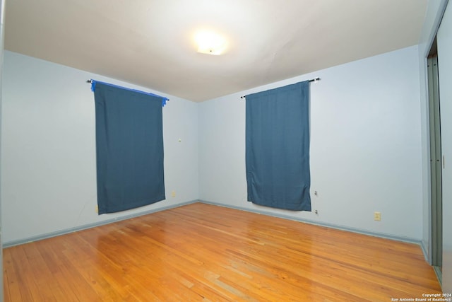 unfurnished room with hardwood / wood-style flooring