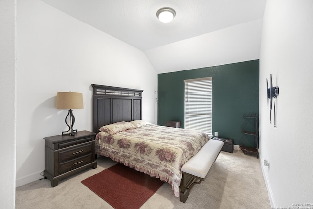 bedroom featuring light carpet and lofted ceiling