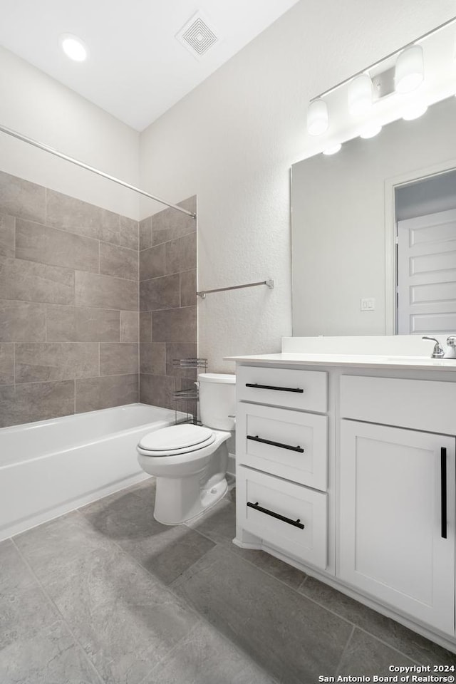 full bathroom with tile patterned floors, vanity, toilet, and tiled shower / bath