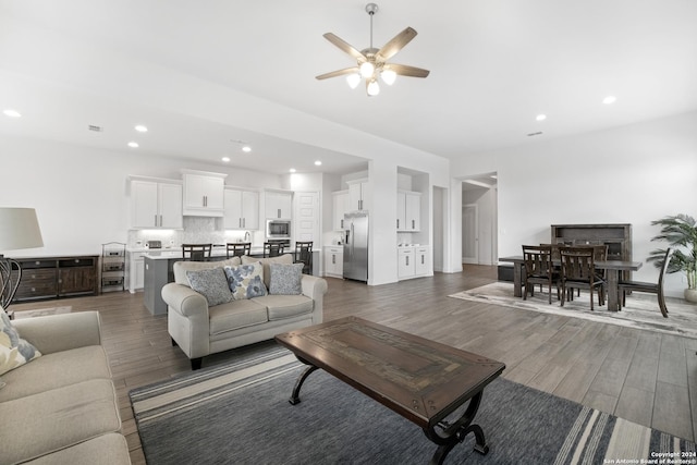 living room with dark hardwood / wood-style floors and ceiling fan