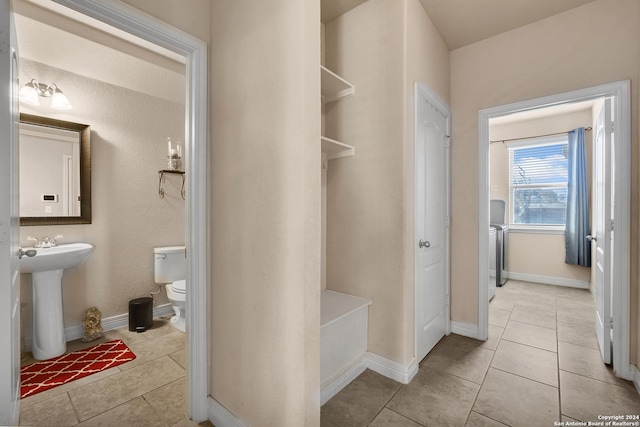 bathroom with tile patterned flooring, toilet, and sink