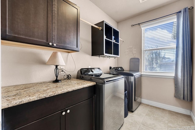 washroom with light tile patterned flooring, cabinets, and independent washer and dryer