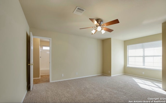 unfurnished room featuring light carpet and ceiling fan