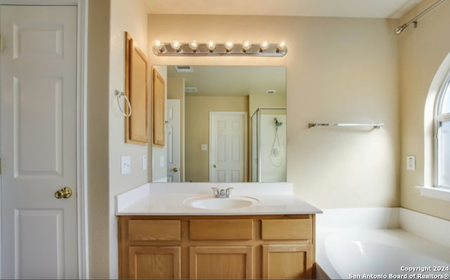 bathroom with vanity and plus walk in shower