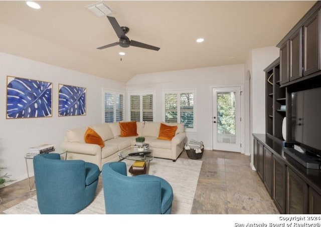 living room featuring ceiling fan and vaulted ceiling