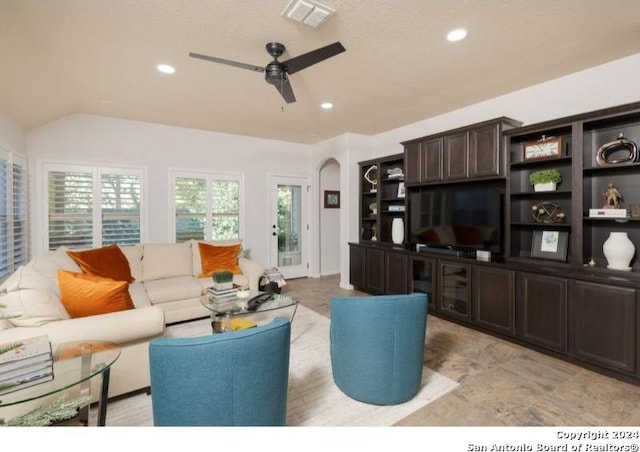 living room with ceiling fan and lofted ceiling