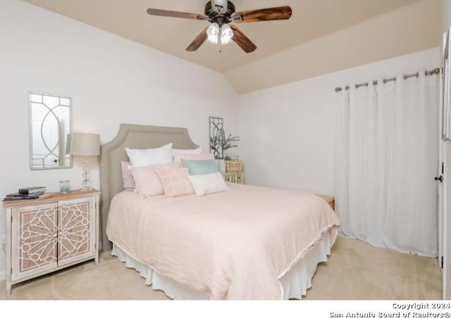 bedroom featuring ceiling fan, light colored carpet, and vaulted ceiling