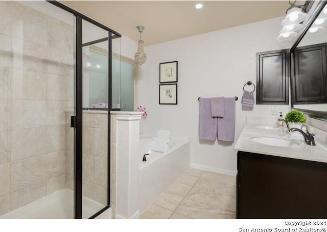 bathroom with vanity and independent shower and bath