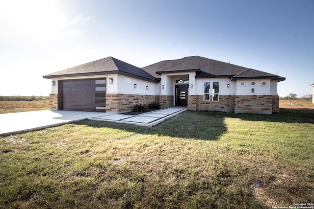 view of front of house featuring a garage and a front yard