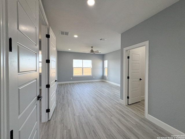 unfurnished room featuring ceiling fan and light wood-type flooring