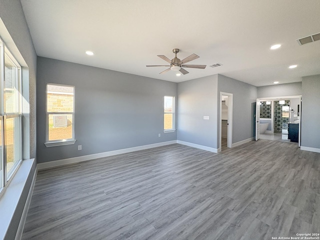 unfurnished living room featuring hardwood / wood-style floors and ceiling fan