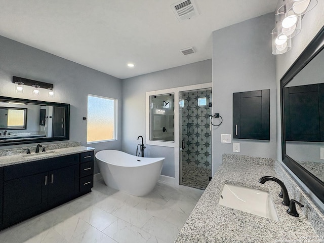 bathroom featuring vanity and shower with separate bathtub