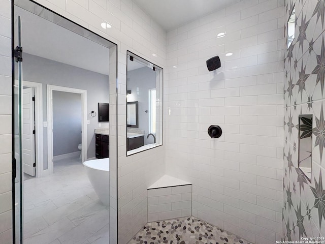 full bathroom with toilet, vanity, and shower with separate bathtub