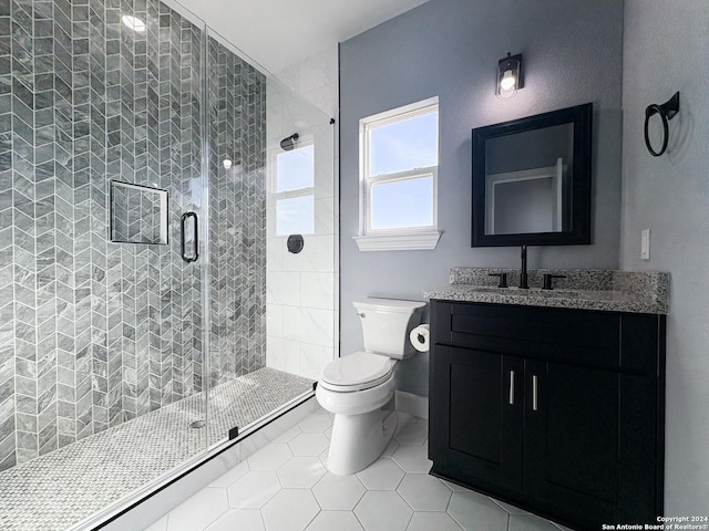 bathroom with toilet, vanity, tile patterned floors, and an enclosed shower