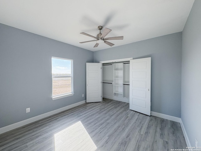 unfurnished bedroom with ceiling fan, light hardwood / wood-style floors, and a closet