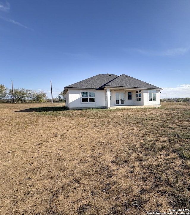 rear view of property with a yard