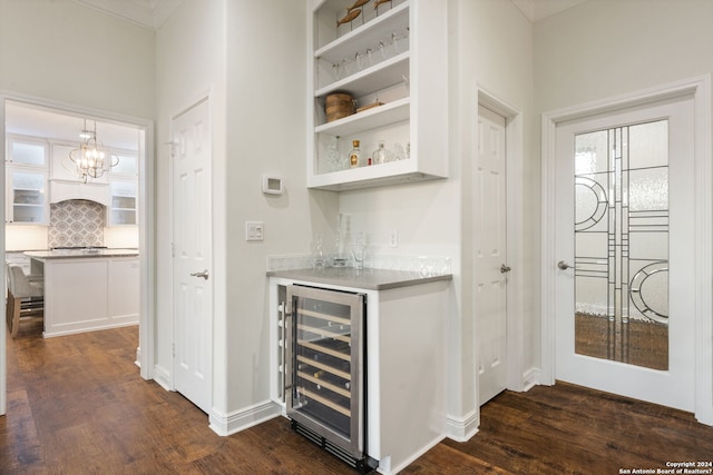 bar with wine cooler, white cabinets, decorative light fixtures, and dark hardwood / wood-style floors