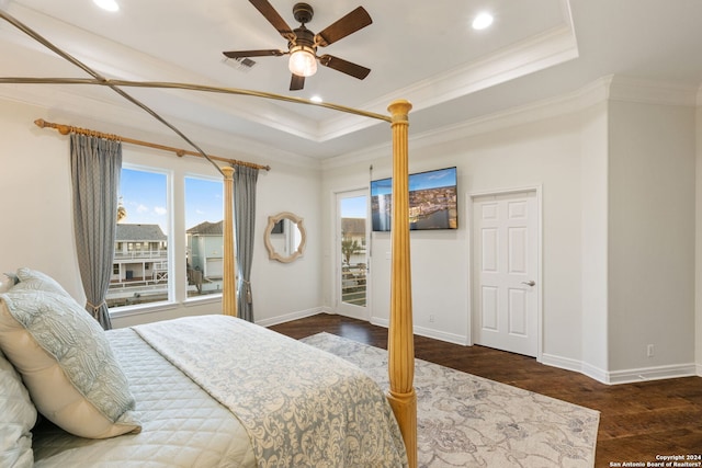 bedroom with a raised ceiling, ceiling fan, crown molding, and dark hardwood / wood-style floors