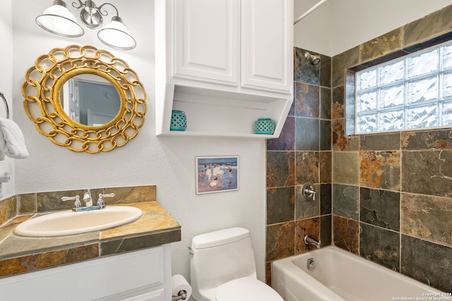 full bathroom with vanity, toilet, and tiled shower / bath