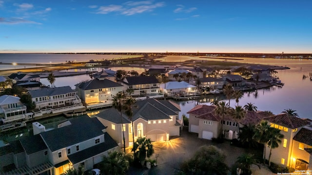 aerial view at dusk with a water view