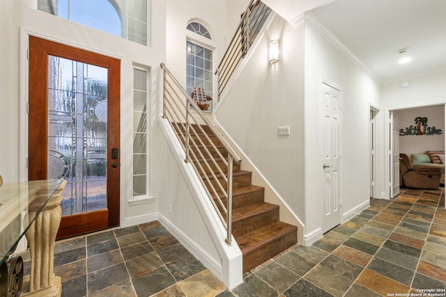 foyer featuring ornamental molding