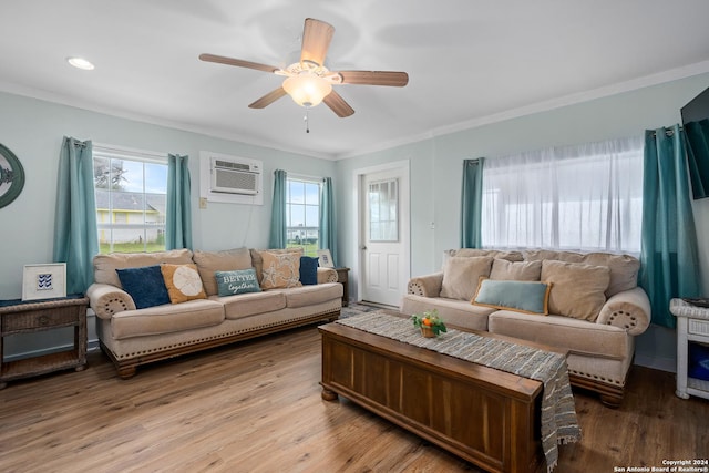 living room featuring a wall mounted air conditioner, light hardwood / wood-style floors, ceiling fan, and ornamental molding