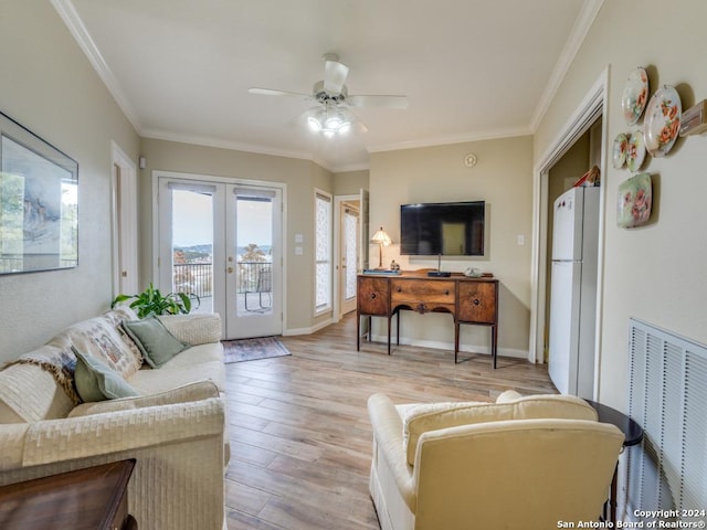 living room with crown molding, french doors, ceiling fan, and light wood-type flooring