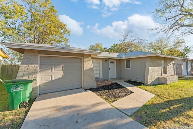 ranch-style home featuring a garage and a front lawn