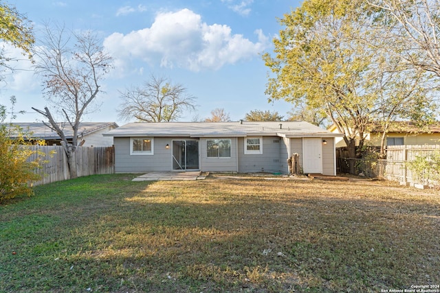 back of house with a lawn