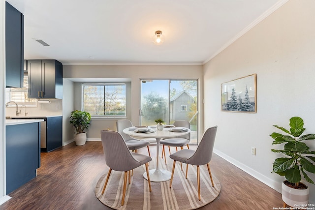 dining space featuring dark hardwood / wood-style flooring and crown molding