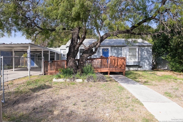 exterior space with a carport and a deck