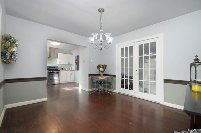 unfurnished dining area with french doors, dark hardwood / wood-style floors, and a notable chandelier