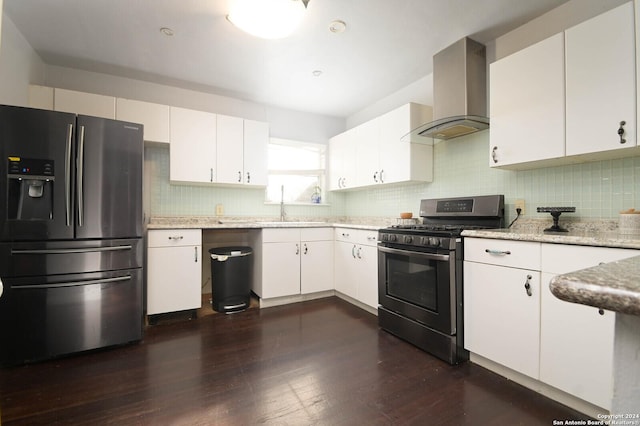 kitchen with wall chimney exhaust hood, stainless steel fridge with ice dispenser, black range with gas cooktop, and white cabinets