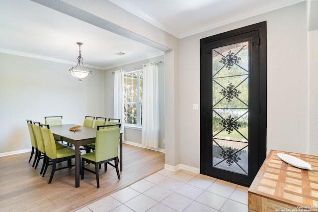 dining area with a wealth of natural light, light hardwood / wood-style flooring, and crown molding