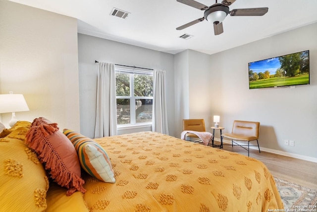 bedroom with ceiling fan and hardwood / wood-style flooring