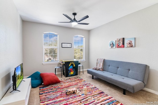 living area with carpet flooring and ceiling fan