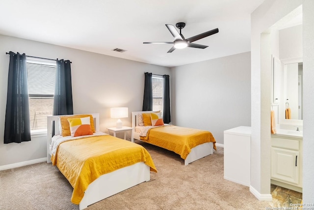 carpeted bedroom featuring ceiling fan and sink