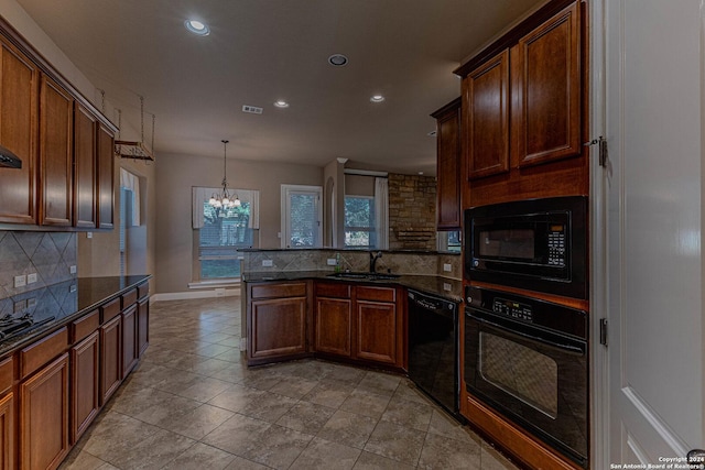 kitchen featuring sink, pendant lighting, a chandelier, decorative backsplash, and black appliances