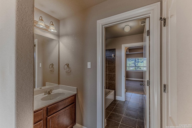 bathroom featuring tile patterned flooring, a textured ceiling, and vanity