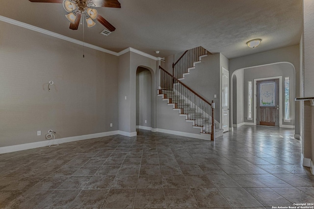 interior space with a textured ceiling, ceiling fan, and crown molding