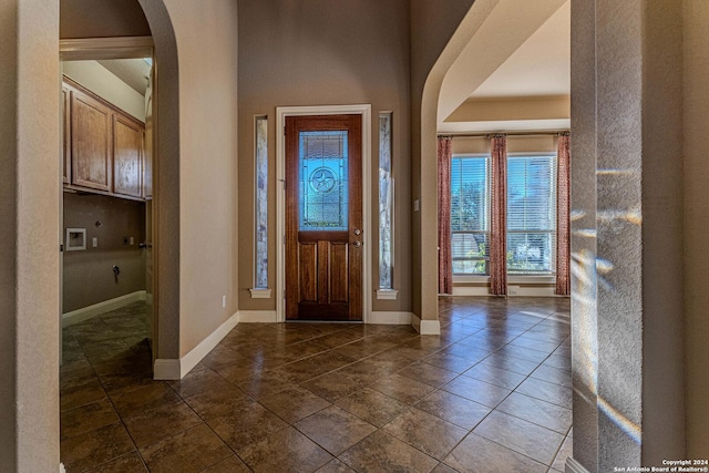 foyer featuring dark tile patterned flooring