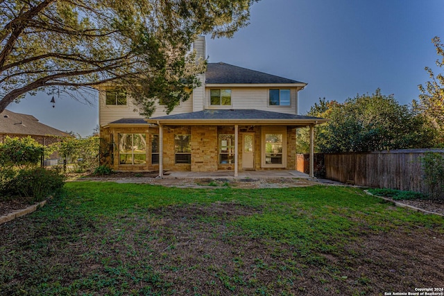 back of property featuring a yard and a patio area